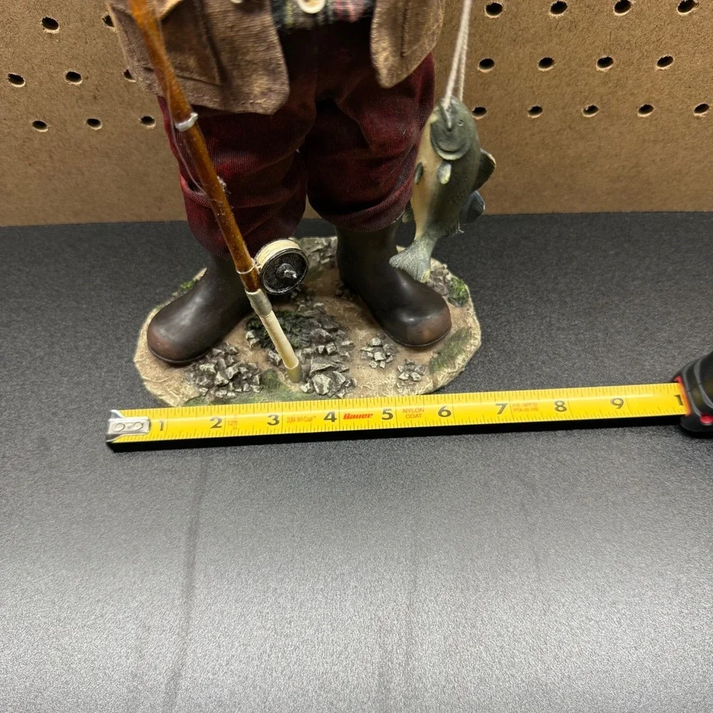 Christmas 2005 Santa fishing figurine holding a fishing pole and fish plastic
